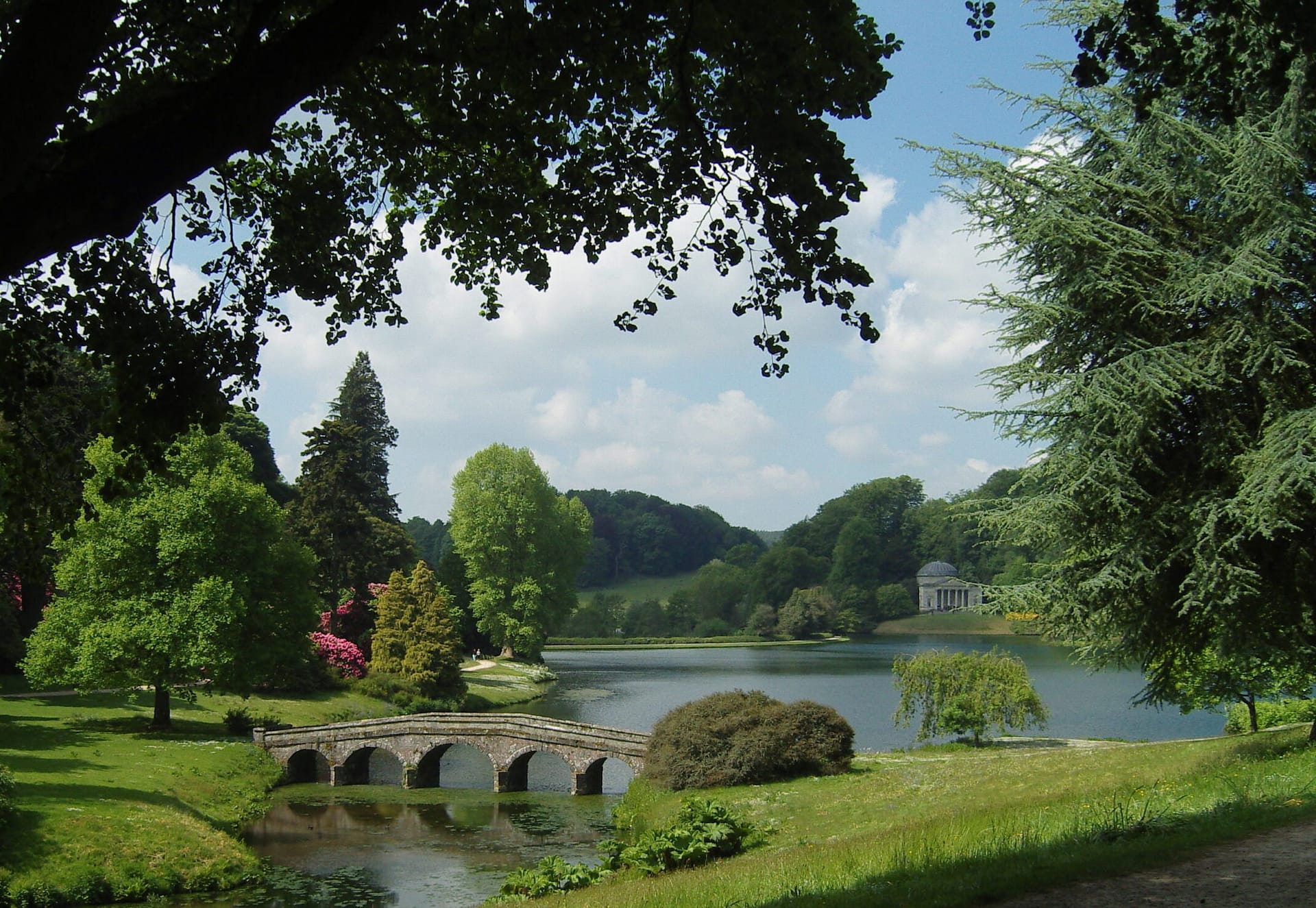 Iconic 18th-century Palladian bridge spanning the still waters of the lake at Stourhead in Wiltshire