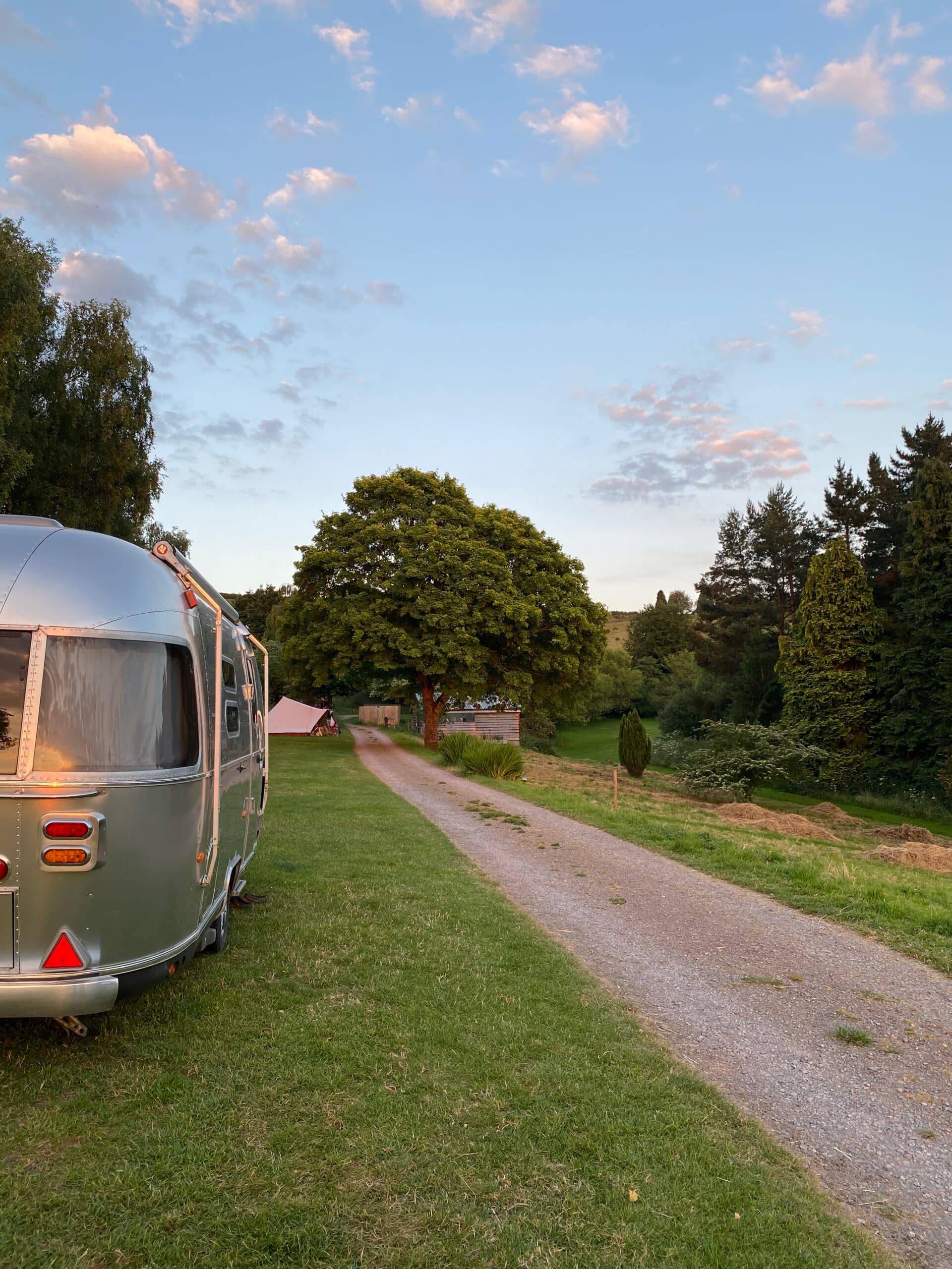 Airstream caravan on Batcombe Vale Campsite as the sun goes down